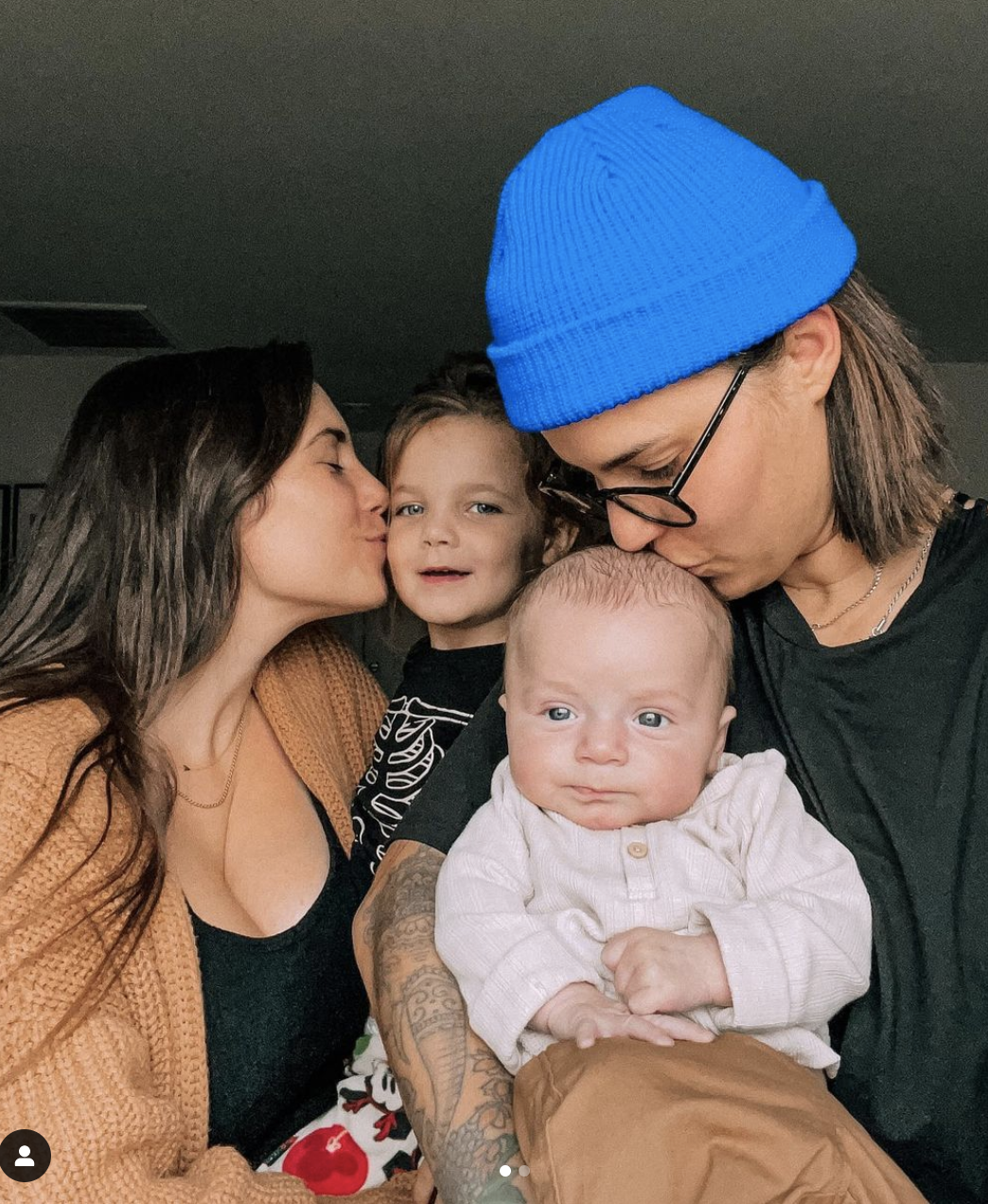 young queer female family posing with their two kids - Queer YouTube Couple