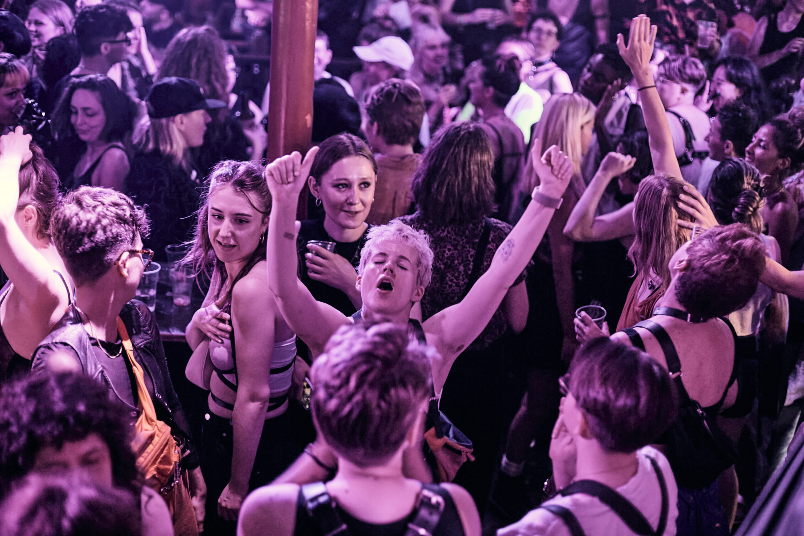 Crowd in BP events dancing and having fun at Clapham Grand. Someone in the middle cheering.