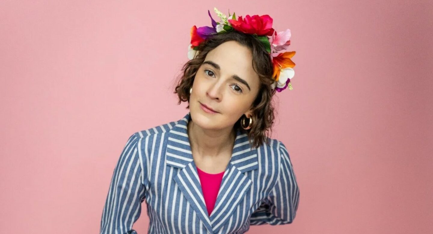 woman wearing a floral crown and striped shirt. 