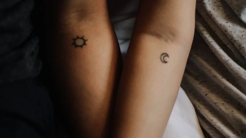two persons showing their hand tattoos