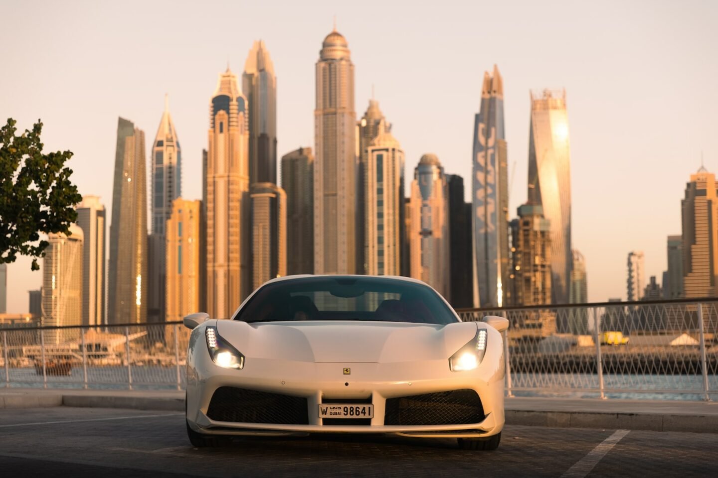 a white sports car parked in front of a city skyline