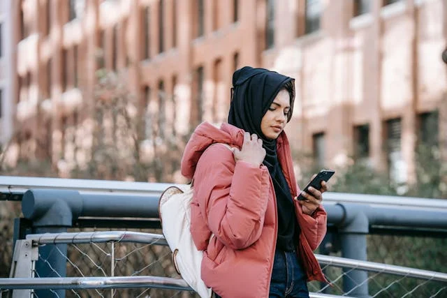 should you respond to being ghosted? woman looking at her phone
