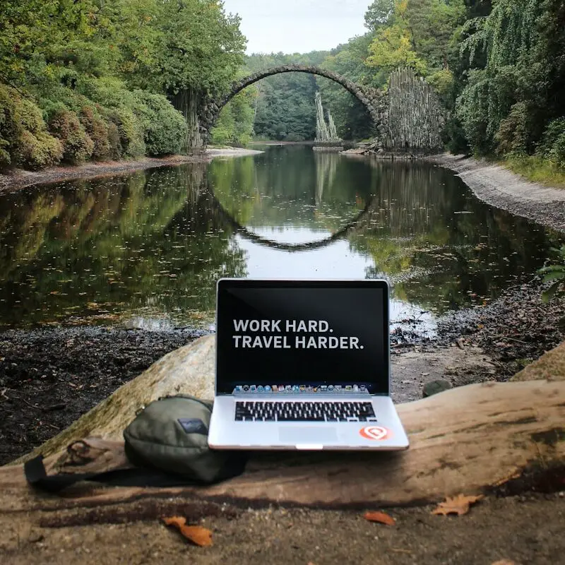 silver MacBook Pro on brown wood log